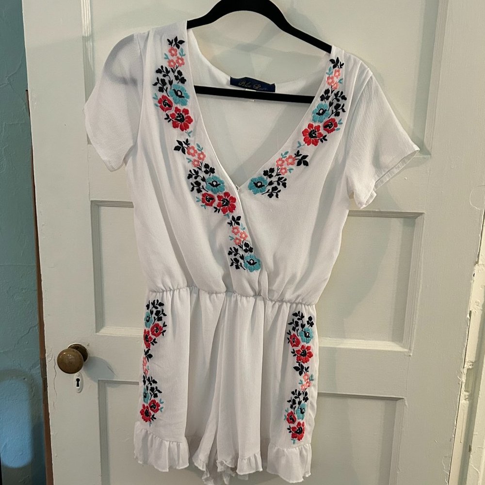Blue Rain Ruffled Romper with floral embroidery from Francesca's